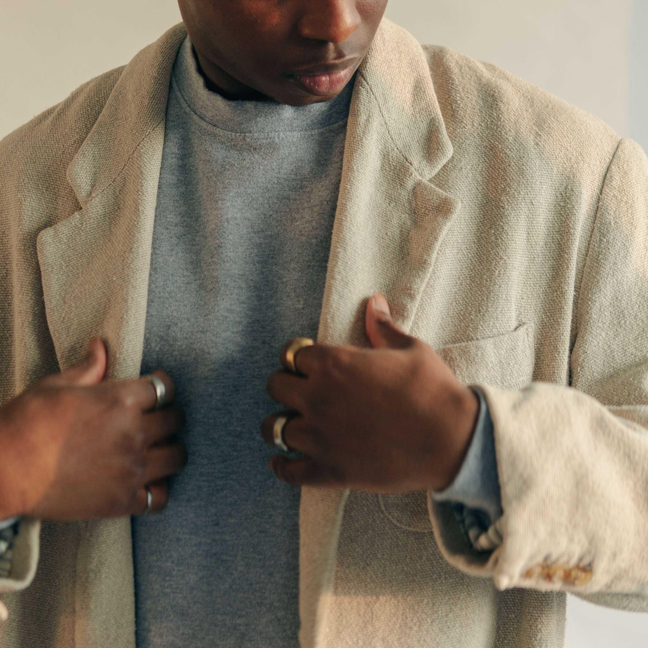 man-adjusting-light-tan-overcoat.png